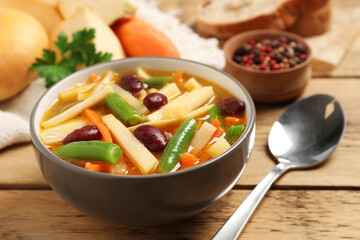 Bowl of delicious turnip soup served on wooden table