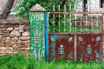 Old rustic gate entrance . Stone fence in village