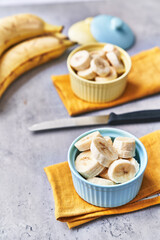  Bowls of slices of banana on a concrete surface