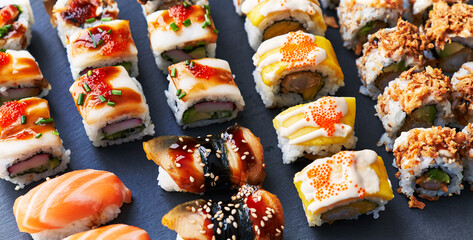  Group of sushi food rolls on a blackboard surface