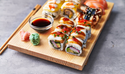  Wooden board of sushi food on a concrete surface