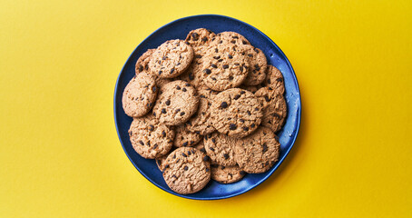  Plate of chocolate cookies on a yellow background