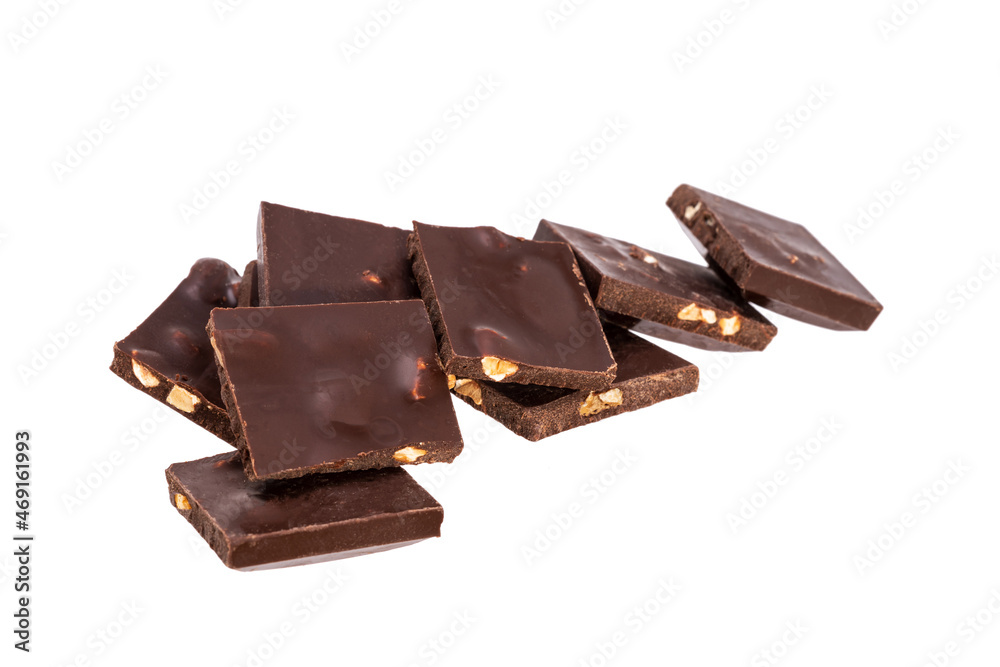 Aufkleber broken pieces of dark chocolate with nuts in a heap isolated on white background