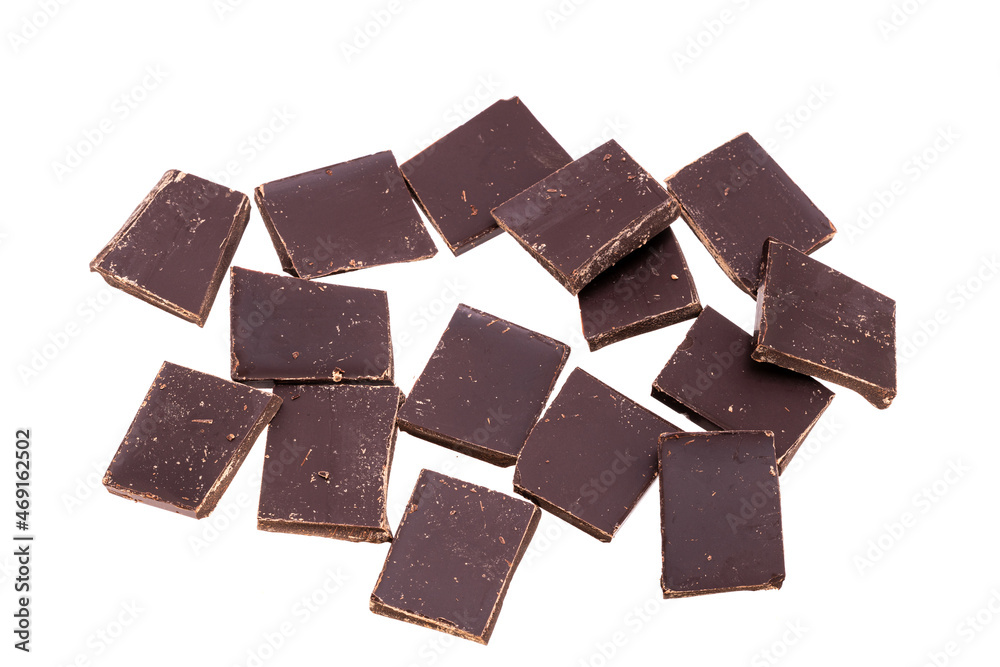 Poster many pieces of dark chocolate in a heap isolated on white background