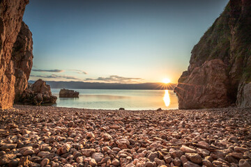 Hidden beach in Vrbnik on the island of Krk in Croatia. Beautiful stone beach between rocks and...