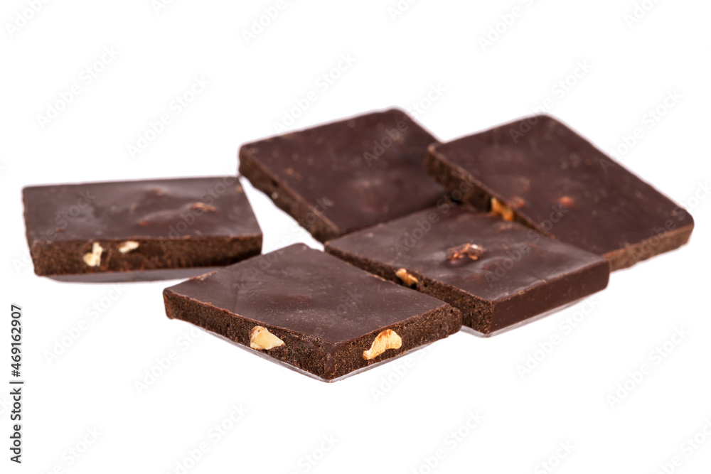 Poster pieces of dark chocolate with nuts in a heap isolated on white background