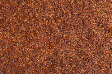 Heap of dry rooibos tea leaves as background, top view