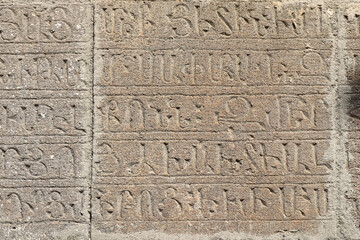 Fototapeta na wymiar Wall with ancient armenian text in Haghartsin Monastery in Haghartsin, Armenia