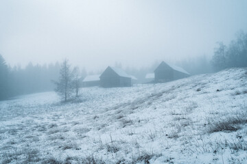 old farm in fog in early winter