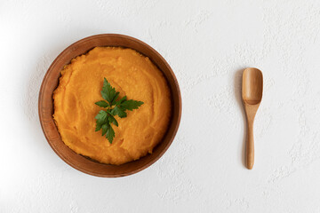 pumpkin soup in a wooden bowl