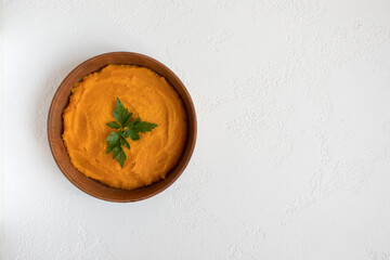 pumpkin soup in a wooden bowl