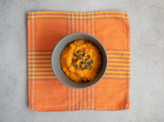 bowl of pumpkin soup with seeds
