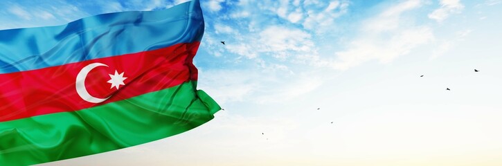 Azerbaijan flag are waving in the spring of the blue sky. 
