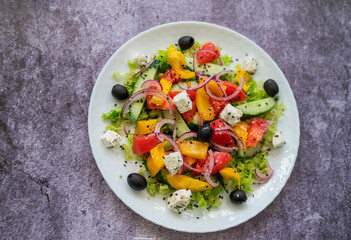 Greek salad dish with feta cheese and olives with vegetables for a healthy meal in a restaurant