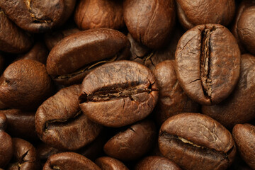 Pile of roasted coffee beans as background, closeup