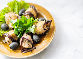 a dish of vegetables eggplant rolls with cheese on a plate