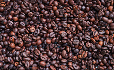 Brown and black coffee beans. Roasted arabic espresso coffee grains.