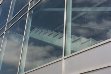 Stairs behind glass facade of a moder building