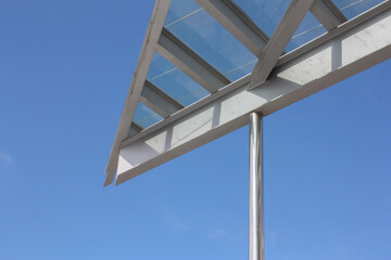 Triangular glass roof cut out against the blue sky
