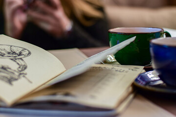 two green blue coffee cups with hot geen tea on table next to cafe restaurant menu