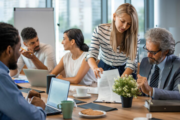 Updating all on the latest business stats. Shot of a group of businesspeople having a meeting in an office. Business people working in the office. Executive directors looking at financial reports