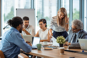 Multi-ethnic group of entrepreneurs discussing business. Finding solutions together. Multi-ethnic...