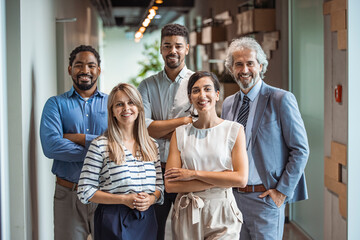 Smiling professional business coaches leaders mentors posing together with diverse office workers...