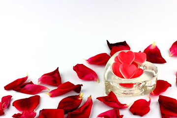 Romantic red love sweets in glass dish with red rose petals