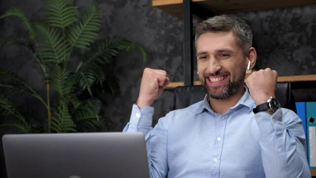 Excited man professional stock trader broker businessman winner looks laptop celebrating good stock market deal in office, rejoices victory. Happy salesman gets new job, reads positive news in email