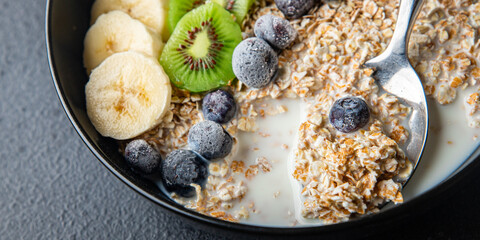 oatmeal bowl fruit breakfast vegetable milk, lactose free, banana, kiwi, berrie, blueberrie meal snack on the table copy space food background
