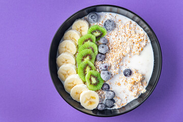 oatmeal bowl fruit breakfast vegetable milk, lactose free, banana, kiwi, berrie, blueberrie meal snack on the table copy space food background