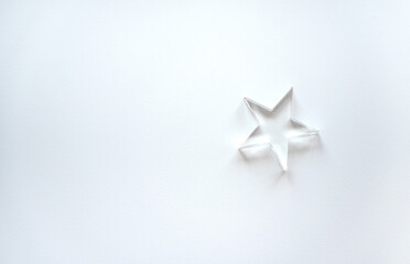 Obraz premium A small glass star on a white isolate.Clean background with a star. The star form.