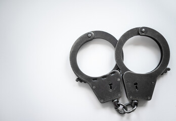 Metal handcuffs on white isolate. Police handcuffs. Arrest of the suspect. Crime.