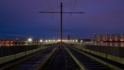 Fototapeta na wymiar Old tram tracks on the North Bridge in Voronezh on an autumn evening