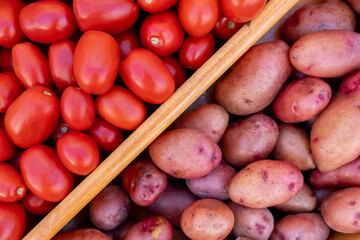 Vegetables on the showcase of a farm store. Eco-friendly products grown at home. Tomatoes and potatoes.