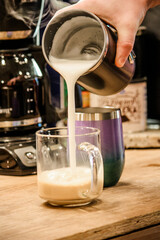 Pouring morning coffee out of a pot 