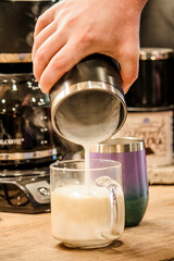 Pouring morning coffee out of a pot 