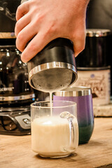 Pouring morning coffee out of a pot 