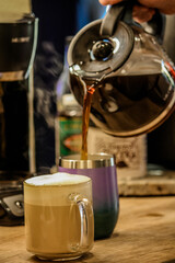 Pouring morning coffee out of a pot 