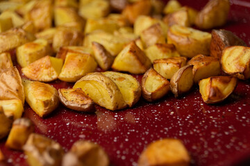 Roasted Potatoes on a Red Baking Sheet