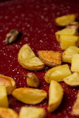Roasted Potatoes on a Red Baking Sheet