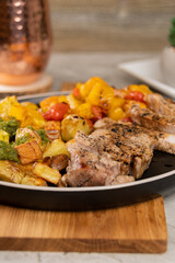 Italian Sheet Pan Pork Chops with Potatoes, Peppers, and Tomatoes 