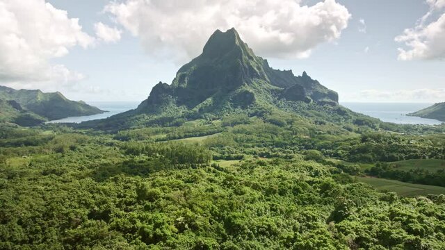 Aerial Tahiti, Drone Moorea island. Tropical green mountain jungle forest of Mount Rotui. French Polynesia luxury travel vacation, paradise getaway, romantic honeymoon exotic destination.  