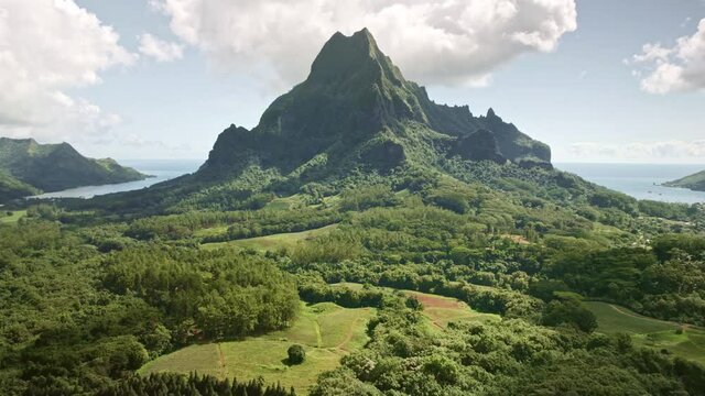 Aerial Tahiti, Drone Moorea island. Tropical green mountain jungle forest of Mount Rotui. French Polynesia luxury travel vacation, paradise getaway, romantic honeymoon exotic destination.  