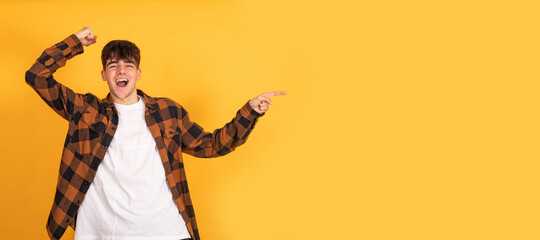 isolated teenager pointing with astonished expression