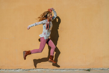 jumping woman isolated on the wall