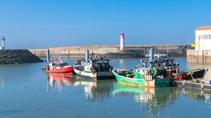 Oleron island in France, the typical harbor of the Cotiniere, with the lighthouse and fishing boats

