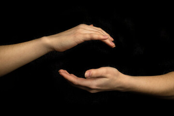 Hand sphere or circle gesture isolated on a black background