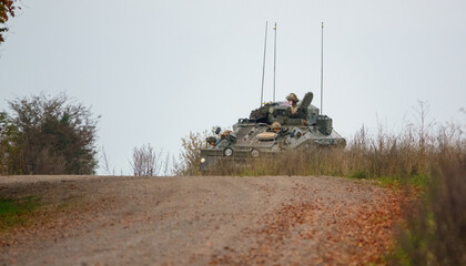 British army FV103 Spartan tracked armored reconnaissance vehicle in action on a military exercise ...
