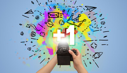 Close-up of a hand holding digital camera with abstract drawing concept